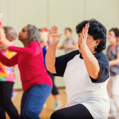 A group of people taking a zumba class.